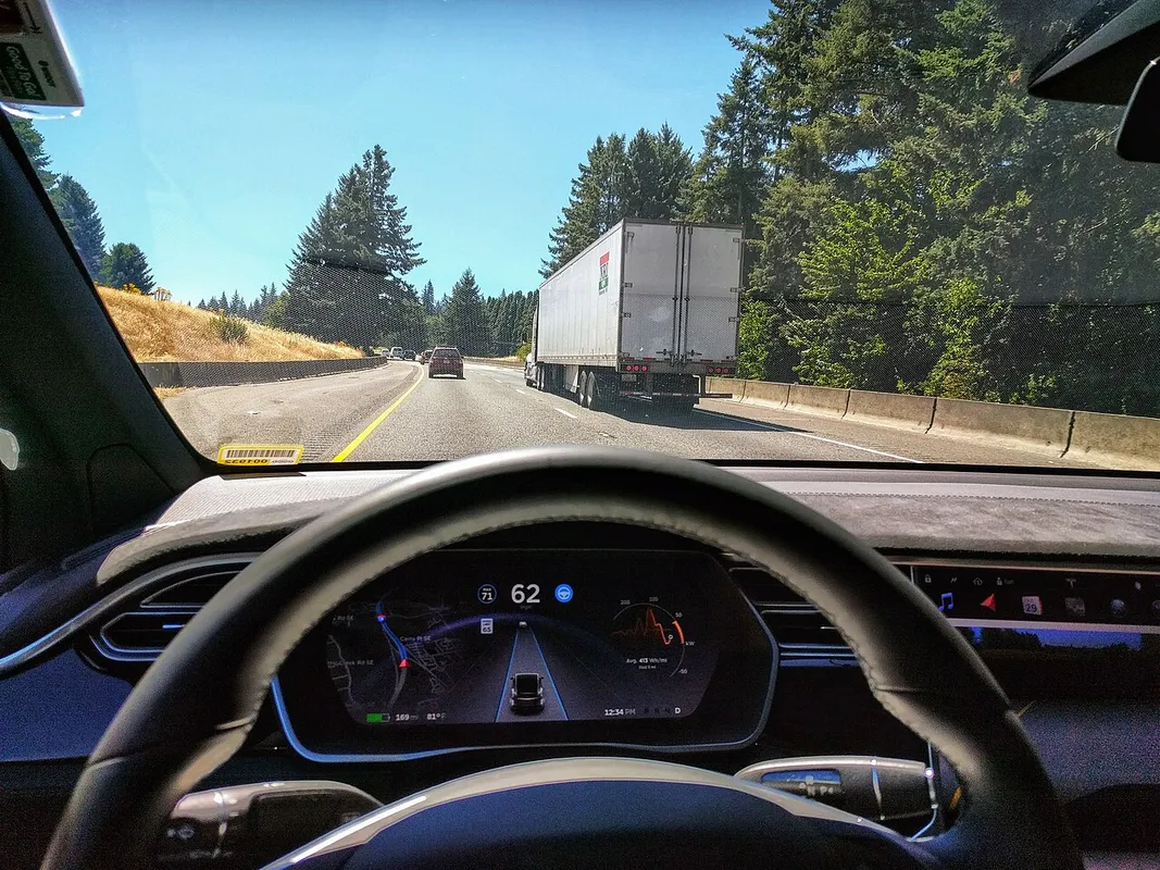 Driving in traffic with Tesla's autopilot controlling distance from the lead car and centering the vehicle in the lane. Vehicle is a 2017 Model X.