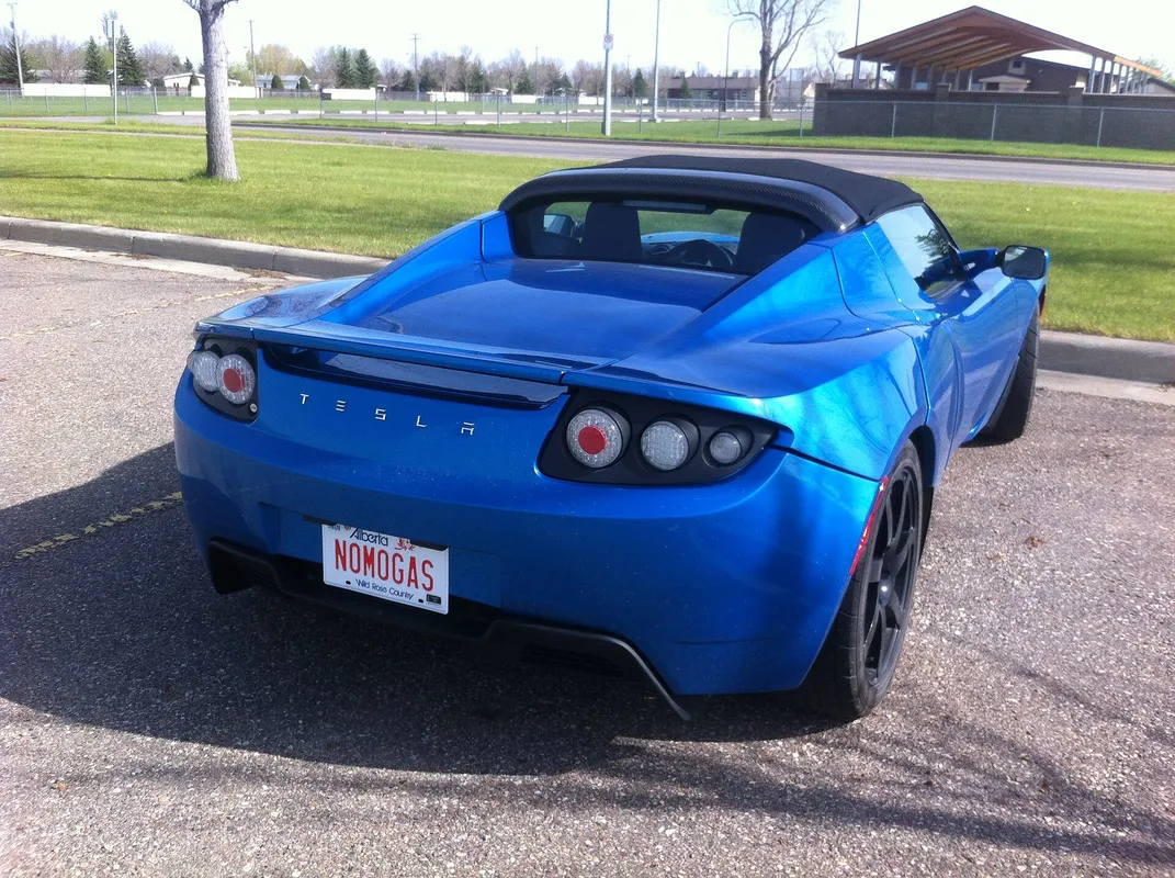 Check out the custom plate on this Tesla Roadster. It is an electric car of course